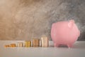 Close-up of pink piggy bank smile with coins stack stair step up growing growth saving money. Royalty Free Stock Photo