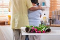 Close up pink rose with Asian Senior husband embrace wife while flower grrangement on table at kitchen at home in Valentine`s Day Royalty Free Stock Photo