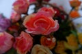 Close up of pink roses fake flowers composition macro, flowers decoration ornamental background, made from fabric and plastic Royalty Free Stock Photo