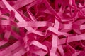 Close-up of pink shredded paper for gifts and stuffing. Place for text