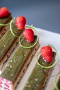 Close-up of pistachio chocolate dessert with strawberries and nuts, catering table setting Royalty Free Stock Photo