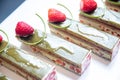 Close-up of pistachio chocolate dessert with strawberries and nuts, catering table setting Royalty Free Stock Photo