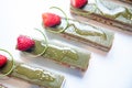 Close-up of pistachio chocolate dessert with strawberries and nuts, catering table setting Royalty Free Stock Photo