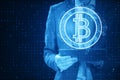 Close up of pixel businessman using tablet with abstract bitcoin hologram on background. Cryptocurrency and finance concept