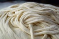 close-up of pizza dough with visible strands, ready to be topped