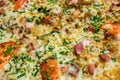 Close-up of pizza with ham, cheese, tomatoes and herbs and bacon. Food background