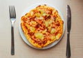 Close up of Pizza with pineapple,  mozzarella cheese, ham, bacon, pizza sauce. Sliced Hawaiian pizza texture with knife and fork Royalty Free Stock Photo