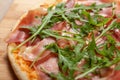 Close up of Pizza with prosciutto parma ham and arugula salad rocket