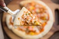 close up pizza with seafood in white plate on wooden table Royalty Free Stock Photo