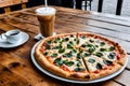 Close-up of a pizza served in a white ceramic plate with tea and cold coffee Royalty Free Stock Photo