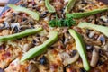 Close up of pizza topping of mushrooms and avocado Royalty Free Stock Photo