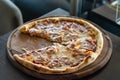 Close up on pizza on the wooden board on the table one piece missing Royalty Free Stock Photo