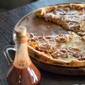 Close up on pizza on the wooden board on the table one piece missing Royalty Free Stock Photo