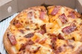 Close up of pizzas with variety of toppings and cheese in cardboard take out boxes with open lid Royalty Free Stock Photo