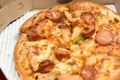 Close up of pizzas with variety of toppings and cheese in cardboard take out boxes with open lid Royalty Free Stock Photo