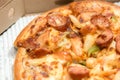 Close up of pizzas with variety of toppings and cheese in cardboard take out boxes with open lid Royalty Free Stock Photo