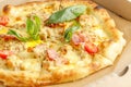 Close up of pizzas with variety of toppings and cheese in cardboard take out boxes with open lid on wooden table Royalty Free Stock Photo