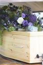 Close Up Of Plain Wooden Coffin With Floral Tributes In Back Of Hearse At Funeral Royalty Free Stock Photo