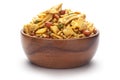 Close up of plane salty Golden Mixture Indian namkeen snacks In hand-made handcrafted wooden bowl