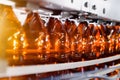 Close up of plastic bottles on a conveyor belt. Industrial production of beer.