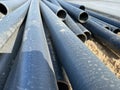 Close-up Plastic main black pipes. A heap of polyethylene pipes for a water supply system. Objects for laying of city Royalty Free Stock Photo