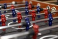 Close-up plastic players in table football in entertainment center. Soccer table with red and blue players Royalty Free Stock Photo