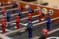 Close-up plastic players in table football in entertainment center. Soccer table with red and blue players Royalty Free Stock Photo