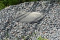 A close-up of a plastic septic tank manhole cover, manhole lid that covers a sewage tank with gravel rocks around Royalty Free Stock Photo