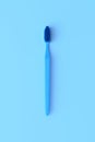 Close-up plastic toothbrush on the blue background with copy space Royalty Free Stock Photo