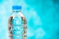 Close up plastic water bottles with caps on blue background Royalty Free Stock Photo