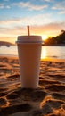 Close up plastic white coffee cup with black straw on sand of beach at sunset or sunrise sunlight