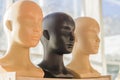Close-up of a plastic woman mannequin heads on wooden rack Royalty Free Stock Photo