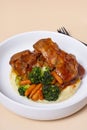 Close-up plate of beef ribs in barbecue sauce with vegetables and mashed potatoes angle view Royalty Free Stock Photo