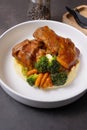Close-up plate of beef ribs in barbecue sauce with vegetables and mashed potatoes on dark background Royalty Free Stock Photo