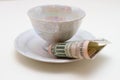 Close-up of plate with cup and bill tip on white table Royalty Free Stock Photo