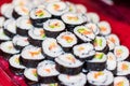 Close up of a plate full with sushi rolls.