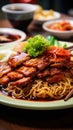 Close-up of a plate of noodles and meat on wooden table. Noodles and the meat is tender and flavorful. Dish is garnished with