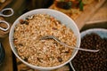 Close-up of a plate of oatmeal with dried fruit on a table with a breakfast cereal balls with cocoa.