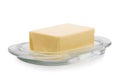 Close-up of a plate with organic butter, isolated on a white background. A nutritious block of butter. Natural food.