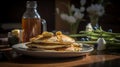 Close up of a plate of pancakes with maple syrup on top on a table. Royalty Free Stock Photo