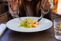 Close up of a plate of pasta topped with shrimp scampi