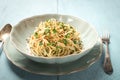 Close-up of a plate of spaghetti AGLIO E OLIO on wooden table