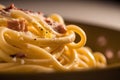 close up of a plate of spaghetti carbonara with bacon and cheese