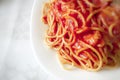 Close up of a plate of spaghetti with tomato sauce
