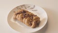 Close-up of plate of sweet pastries on white table. Stock footage. Beautiful and delicious pastries in coffee shop Royalty Free Stock Photo