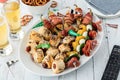 Close up of a platter full of game day appetizers served with beer. Royalty Free Stock Photo