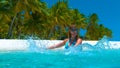 CLOSE UP: Playful woman on vacation splashing the glassy water with her hands. Royalty Free Stock Photo