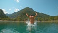 CLOSE UP: Playful man having fun during summer vacation in Slovenian mountains. Royalty Free Stock Photo