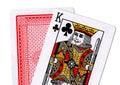 Close up of playing cards with the king of clubs revealed.