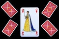 Close up of playing cards. Queen of hearts and four inverted cards.